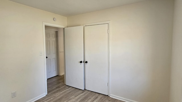 unfurnished bedroom with light wood-type flooring