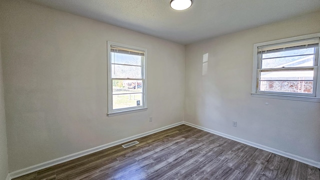 spare room featuring dark hardwood / wood-style flooring