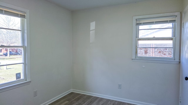 empty room featuring dark hardwood / wood-style floors and a healthy amount of sunlight