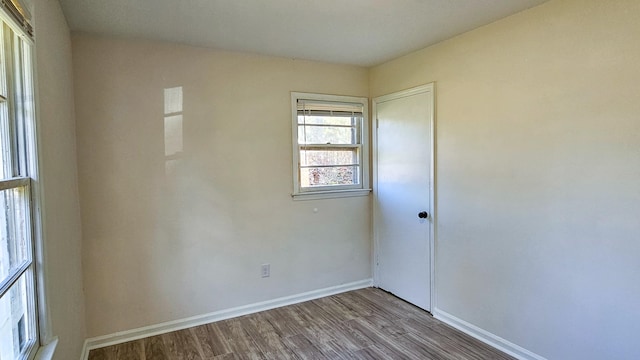 unfurnished room with wood-type flooring