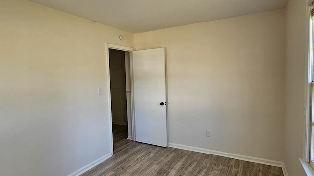 unfurnished room featuring hardwood / wood-style flooring