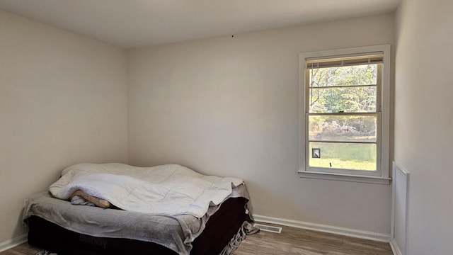 bedroom with hardwood / wood-style flooring