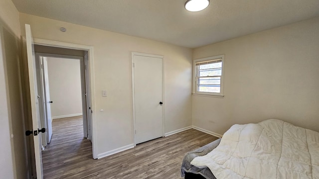 bedroom with hardwood / wood-style flooring