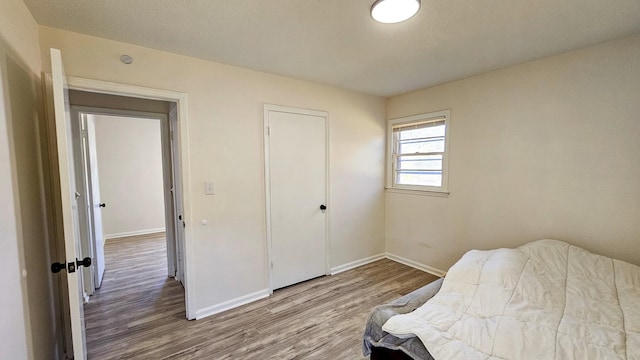 bedroom with hardwood / wood-style floors