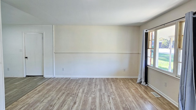 unfurnished room with light wood-type flooring