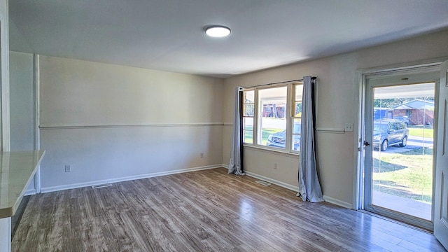 empty room featuring hardwood / wood-style flooring and a wealth of natural light