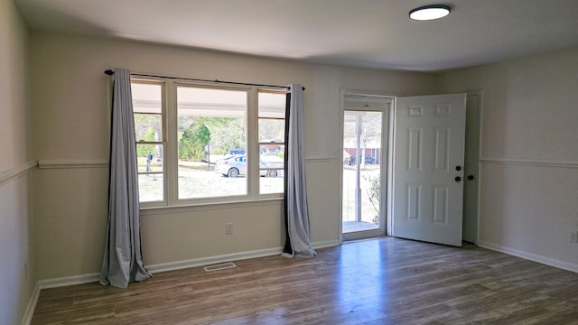 spare room with dark wood-type flooring