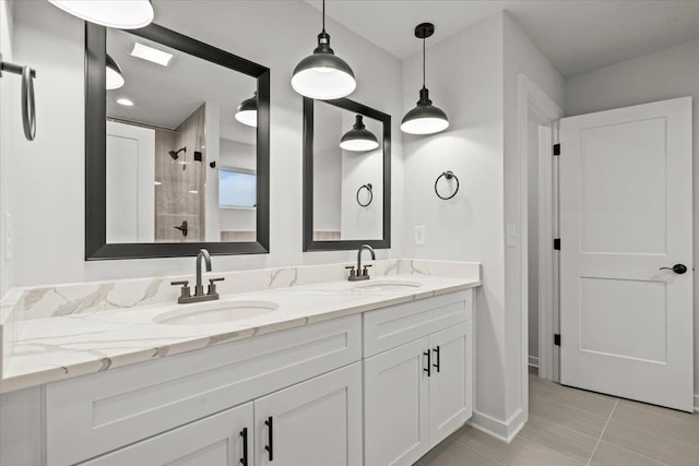 bathroom featuring a tile shower, tile patterned flooring, and vanity