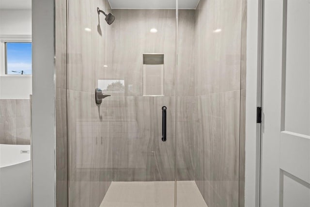 bathroom with a shower with door