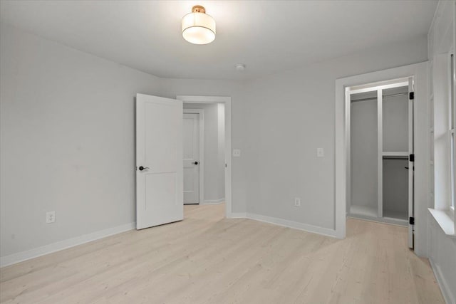 unfurnished bedroom featuring a closet and light hardwood / wood-style flooring