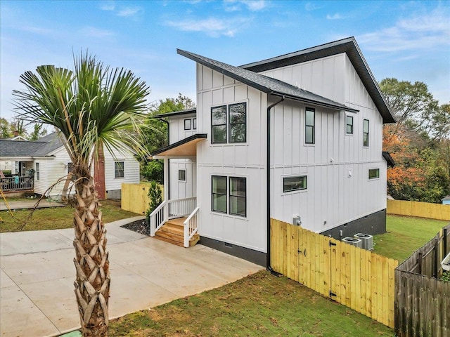 view of front of property featuring a patio and cooling unit