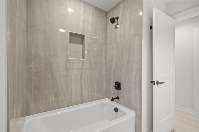 bathroom featuring hardwood / wood-style flooring and tiled shower / bath