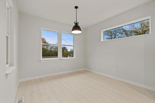 empty room with light hardwood / wood-style flooring