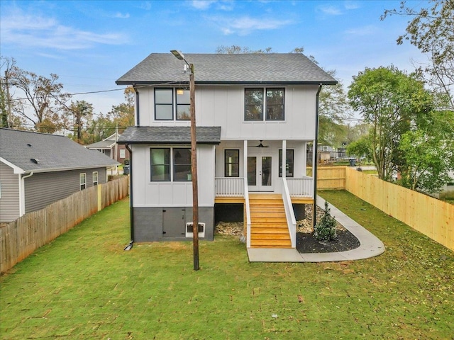 rear view of house with a yard, ceiling fan, and french doors