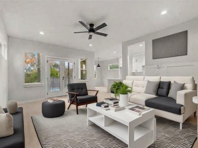 living room with ceiling fan and french doors