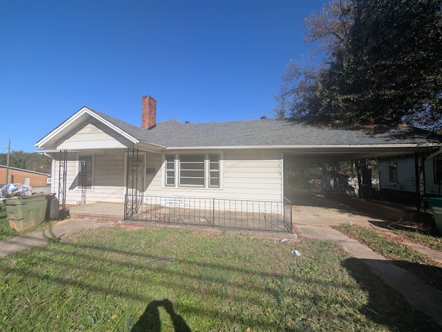 view of front of property featuring a front lawn, a porch, and a carport