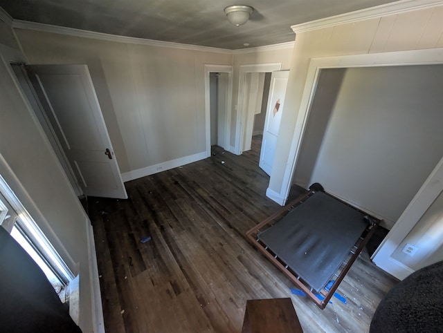 unfurnished bedroom featuring dark wood-type flooring and ornamental molding