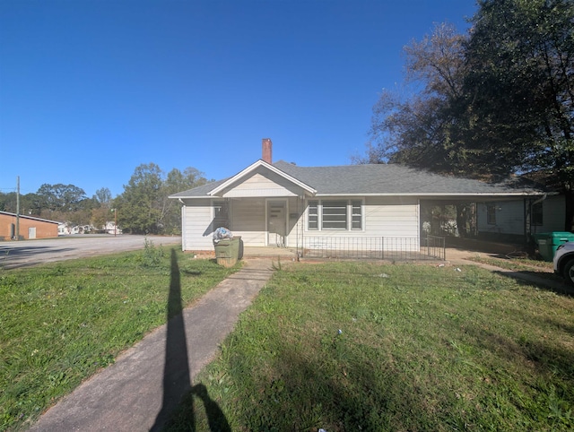 single story home with covered porch and a front lawn