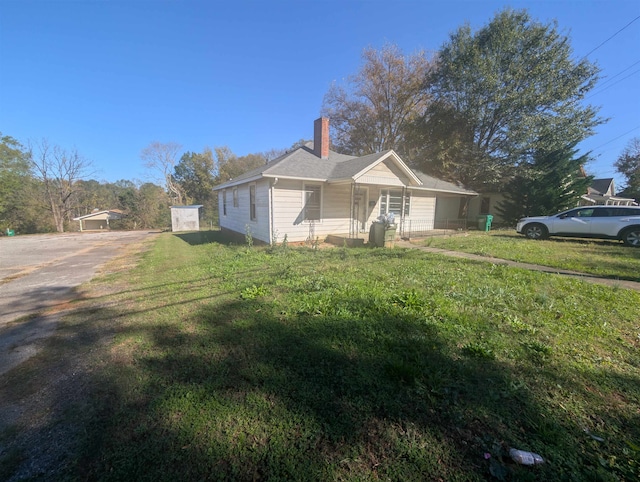 view of side of property featuring a yard and a porch