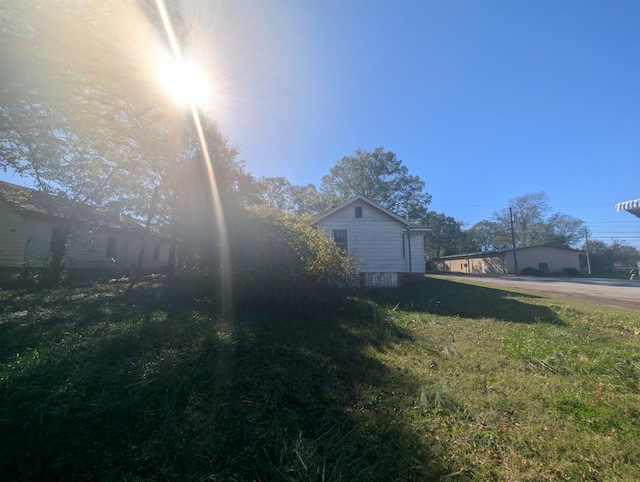 view of property exterior with a yard