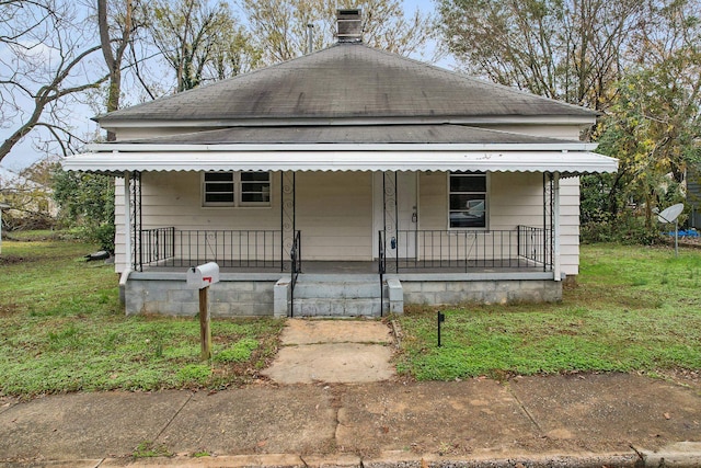 bungalow-style home with a front yard and a porch