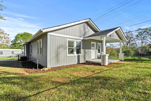 back of property with a porch and a lawn