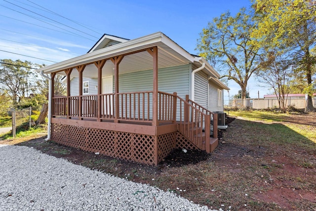 view of front facade featuring covered porch and central AC unit