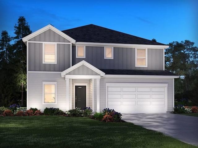 view of front of home featuring a garage and a yard