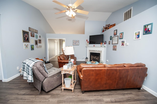 living room featuring a fireplace, ceiling fan, hardwood / wood-style floors, and vaulted ceiling