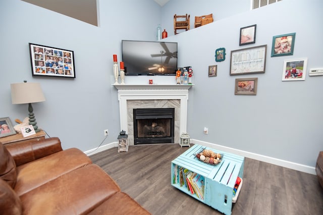 living room with dark hardwood / wood-style flooring and a fireplace