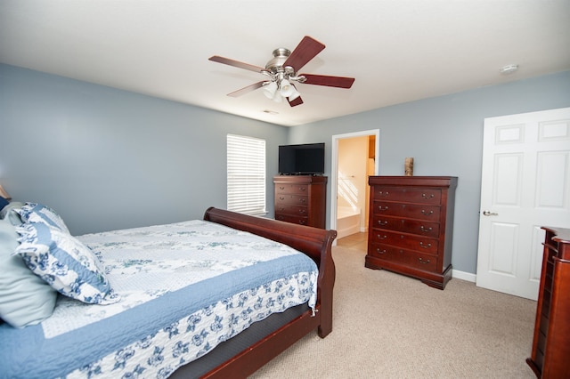 carpeted bedroom featuring ceiling fan and ensuite bathroom