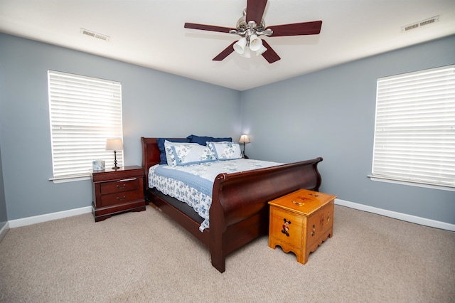 bedroom with ceiling fan and light colored carpet