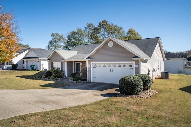 view of front of home with a garage, a front lawn, and cooling unit