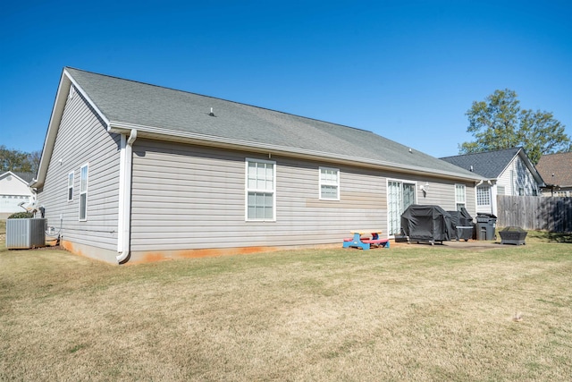 rear view of property with a lawn and central AC