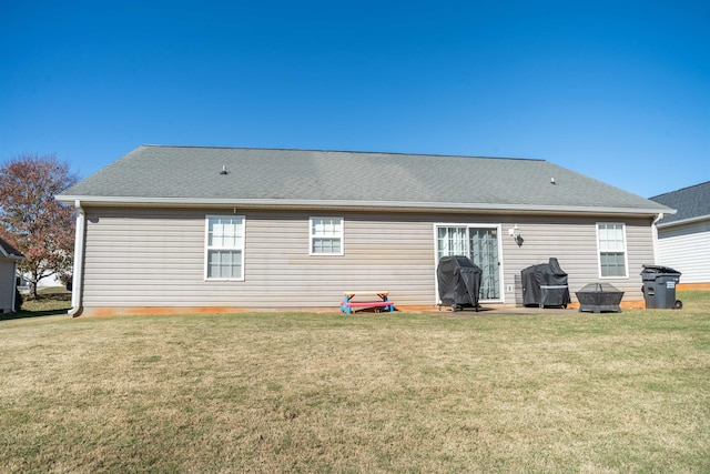 back of house featuring a lawn