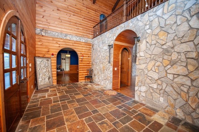 hallway with high vaulted ceiling and wooden ceiling