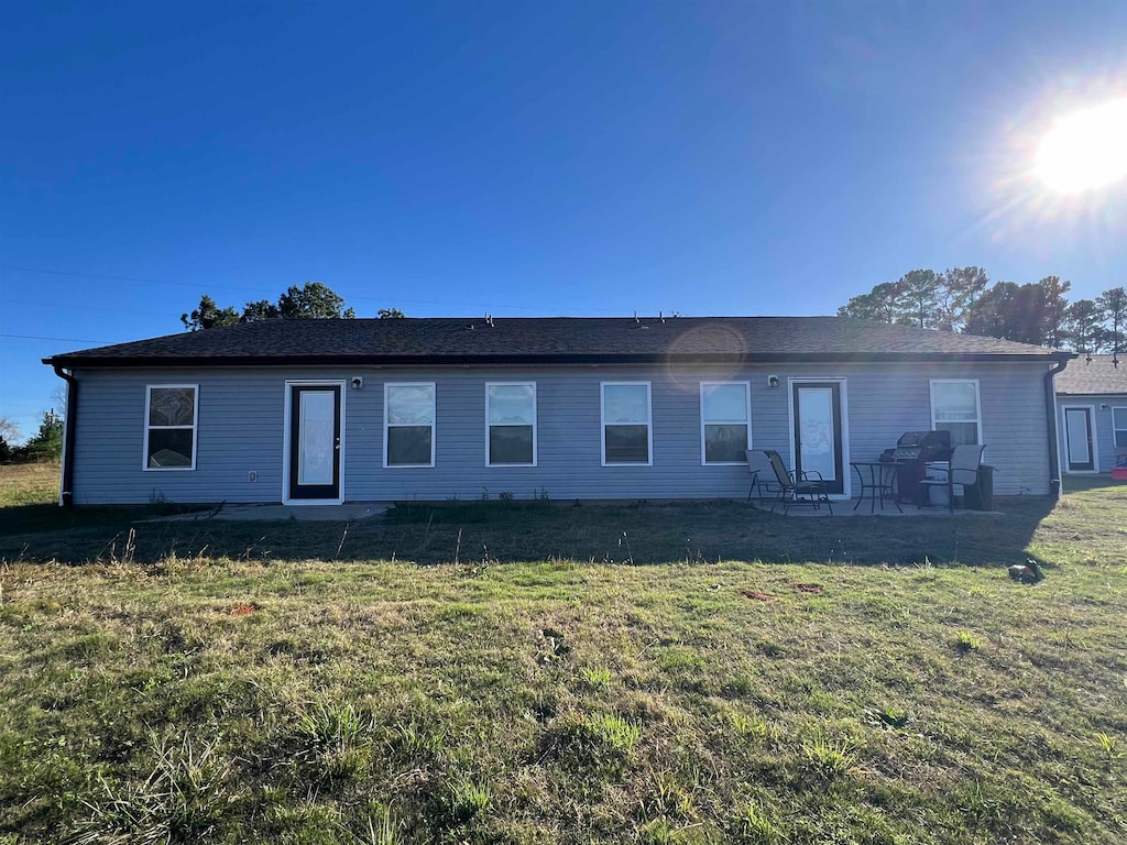 back of house featuring a patio and a lawn