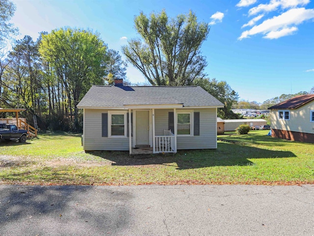 bungalow-style house with covered porch and a front yard