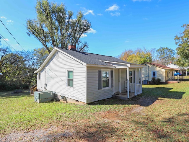 exterior space with a lawn and cooling unit