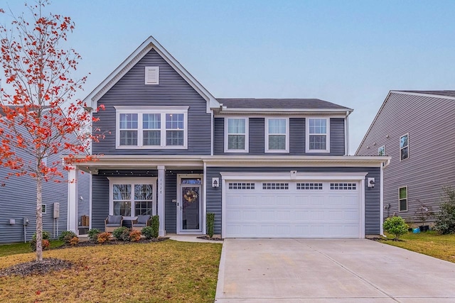 view of front of property with a garage and a front yard