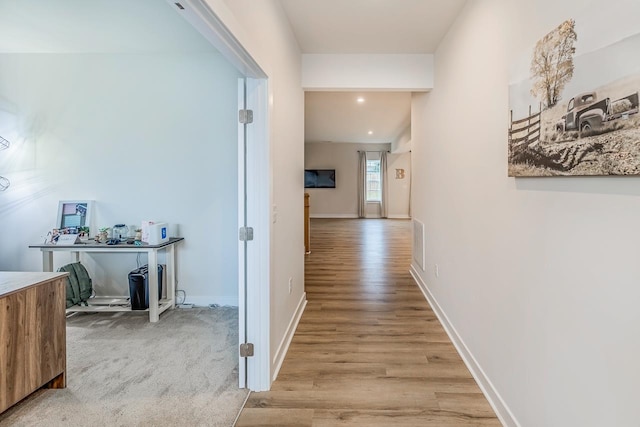 corridor with light hardwood / wood-style flooring