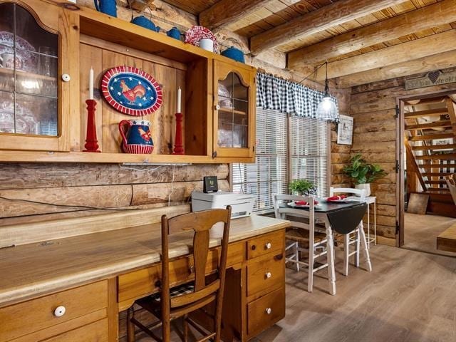 bar with beam ceiling, decorative light fixtures, light hardwood / wood-style flooring, and wooden ceiling