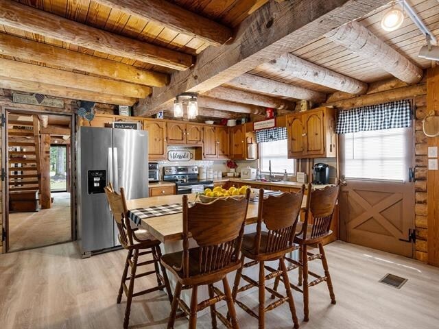 kitchen featuring light wood-type flooring, stainless steel appliances, and plenty of natural light