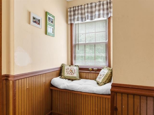 sitting room featuring wood walls