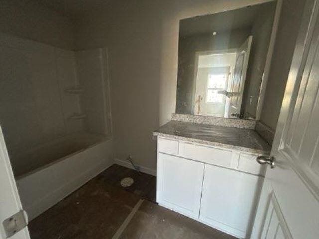 bathroom with washtub / shower combination and vanity