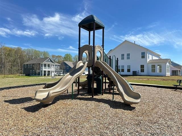 view of play area featuring a lawn and central AC