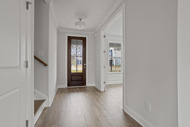 foyer featuring hardwood / wood-style floors and crown molding