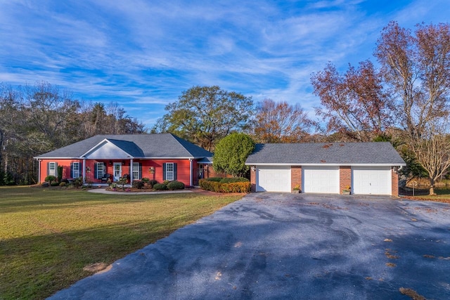 ranch-style house featuring a front lawn and a garage