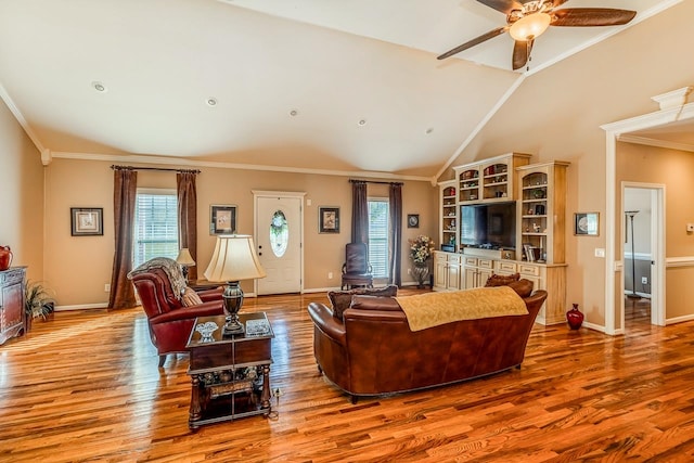 living room with hardwood / wood-style floors, vaulted ceiling, a wealth of natural light, and crown molding