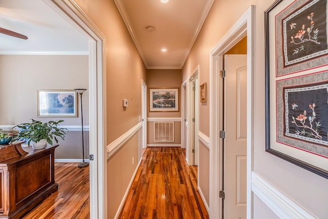 corridor featuring ornamental molding and dark wood-type flooring